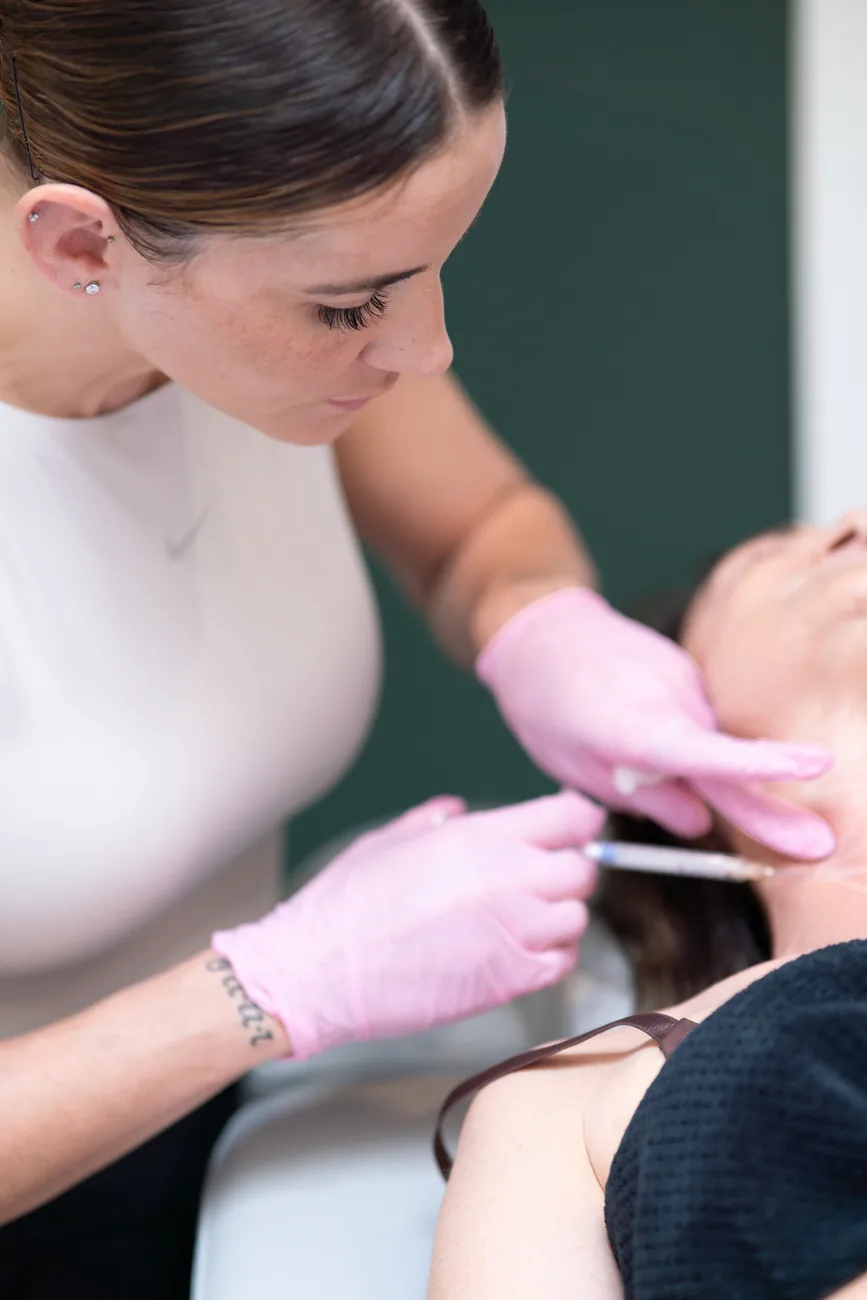 A Diversions injector performing a precise facial treatment in the studio