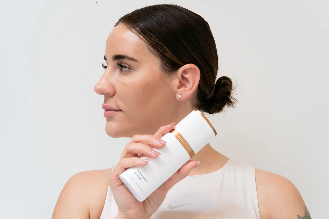 A Diversions client holding a medical-grade skincare product