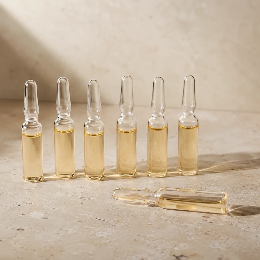 Glass vitamin ampoules on a stone surface